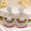 Trendy statement jhumka earrings for women with colorful stones and pink beads Designer jhumka earrings for party wear with luxury crystal shine Beautiful desi jhumka earrings with detailed stone work and hanging beads